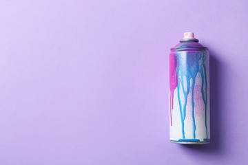 Used can of spray paint on color background, top view. Space for text
