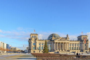 Fototapeta na wymiar Scenery in front of Reichstagsgebäude ,German parliament building, from Platz der Republik park and background of Berlin skyline with Berliner fernsehturm in winter.
