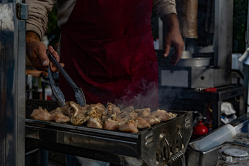 Man cooking chicken on a food truck