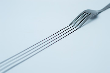 a black trail from a fork on white papers