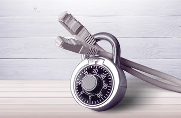 Lock and network cable on background.