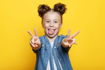 Little girl showing two hands with victory gesture
