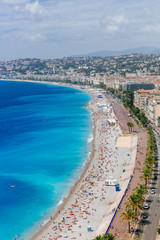 Fototapeta na wymiar Buildings and beaches next to blue sea in the city of Nice, France