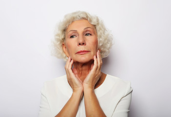 senior woman feeling blue worried about problems, pensive upset sad middle aged grey haired lady