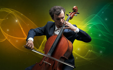 Fototapeta premium Serious classical cellist with fabled sparkling wallpaper