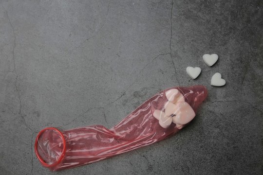 White hearts look like sperm in red 52mm comdom