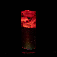 Red Sparkling iced alcohol drink with isolated black background