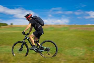 Obraz premium Natural view with cyclist going somewhere with stylish bike