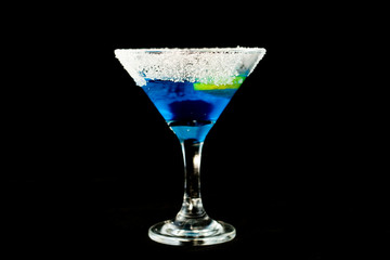 Blue kamikaze cocktail with vodka, lime juice, blue curacao, sugar and lime wedge