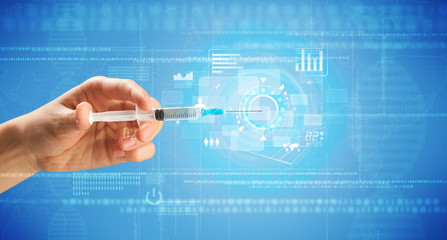 Female doctor hand holding syringe with blue background and charts