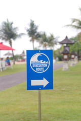 Tsunami evacuation way sign on the tropical island