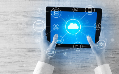 Hand touching tablet with cloud computing and online storage concept
