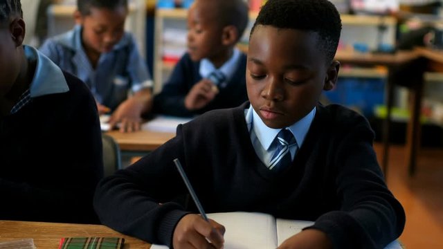 African American boy schoolkid studying in the classroom 4k