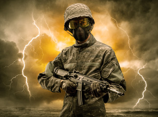 Armed soldier standing in rainy obscure weather
