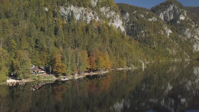 Aerial, drone shot, above the water, around a valley, mountains reflecting from a lake, on a sunny and foggy morning, at Toplitzsee, near grundlsee, in Liezen, Austria