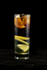 Cuba Libre cocktail with rum, coke and lime juice with lime wedge and full of ices