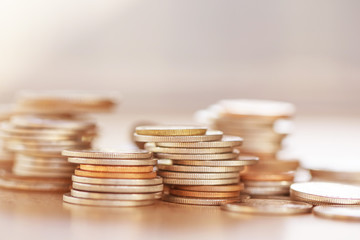 Row of coins on wood background for finance and Saving concept,Investment, Economy, Soft focus and dark style.