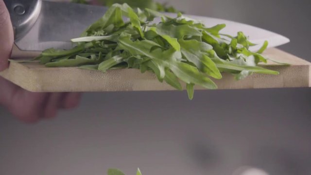 Falling of arugula into the frying pan. Slow motion 480 fps