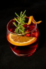 Gotfather cocktail with bourbon whiskey, amaretto, orange wedge and rosemary