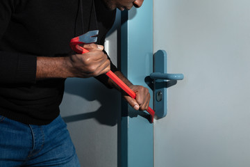 Thief Trying To Break The Door With Crowbar