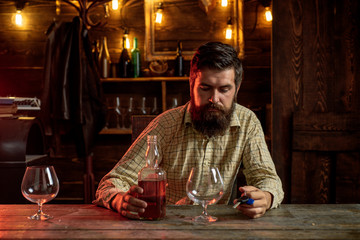 Swag guy with alcohol at home. Drink barman. Pub retro vintage interior. Hipster barman concept. Drunk man. Whiskey, brandy, cognac concept.