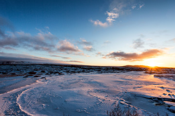 Sunset on icelandeic tundra with snow and ice