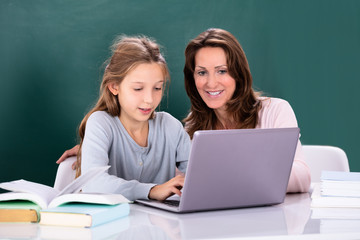 Teacher Teaching Girl On Laptop