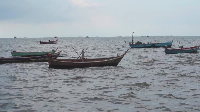 Many small fishing boats of local fisherman in Thailand. Skyline at sea.