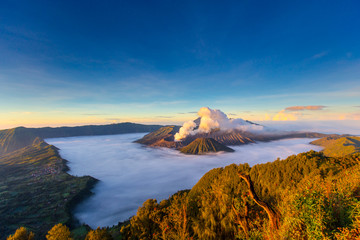 Bromo Mountain and fog around bromo mountain with sunrise from seruni viewpoint is an active volcano and part of the Tengger massif, in East Java, Indonesia. Indonesian call Gunung Bromo.