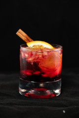 Red cocktail with pomegranate, lemon and alcohol.
