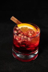 Red cocktail with pomegranate, lemon and alcohol.