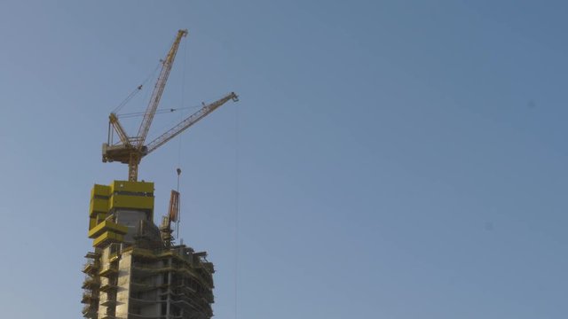 Crane on top of a skyscraper during construction, Dubai, UAE
