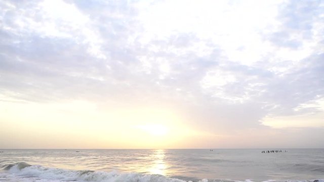 Slow motion of waves in the ocean during sunrise.