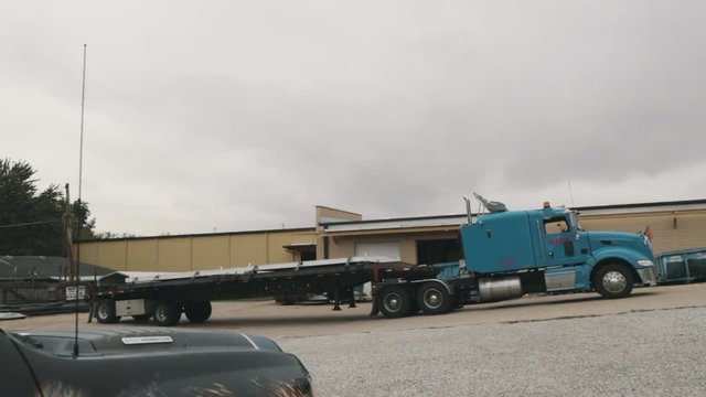 Zooming out of parked Peterbilt semi truck in slow motion.