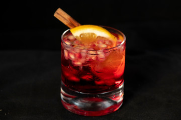 Red cocktail with pomegranate, lemon and alcohol.