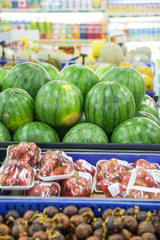 Pile of fresh watermelon on the fruit shelf in the supermarket