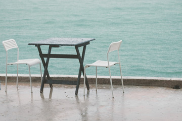 Fototapeta na wymiar table and chairs on the beach at Chao Samran beach, thailand