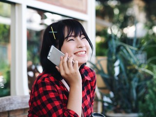 woman talking on mobile phone in cafe