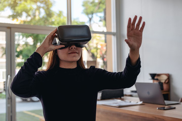An asian woman wearing VR camera while enjoy playing games