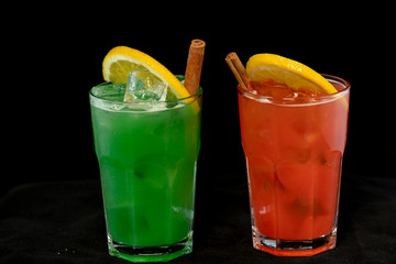 Red and Green Cocktails with red and green juices, alcohol and lime wedge