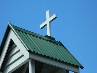 White cross on top of an old church building