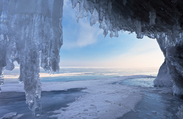 Lake Baikal in winter. View of the endless ice expanse of the lake from the grotto in the coastal cliffs