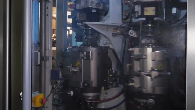 Plastic preform bottles move through the machine for blowing