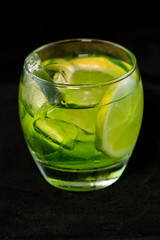 Green cocktail with gin, bitter lemon, basil and lemon