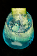 Blue cocktail with blue curacao, mint, gin and cucumber