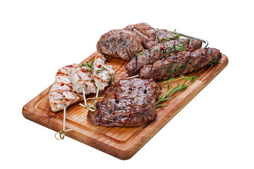 Set of grilled meat on a wooden Board. Chicken fillet, beef steak, pork medallion, lamb kebab. On a white background