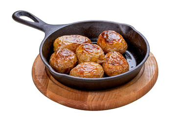 Baked whole potatoes in the pan. On a white background.