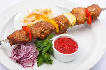 shashlik on skewer with red sauce