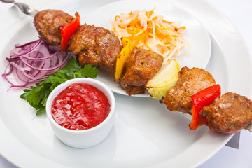 shashlik on skewer with red sauce