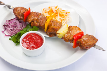 shashlik on skewer with red sauce